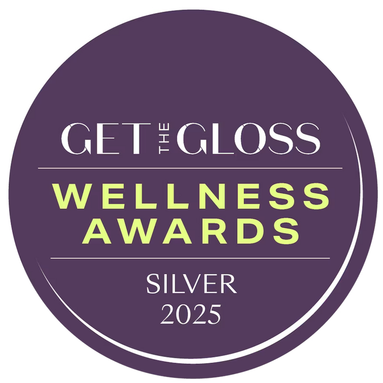 Round badge with 'Get the Gloss Wellness Awards Silver 2025' text on a purple background