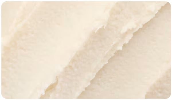 Close-up of a textured shea butter formula.